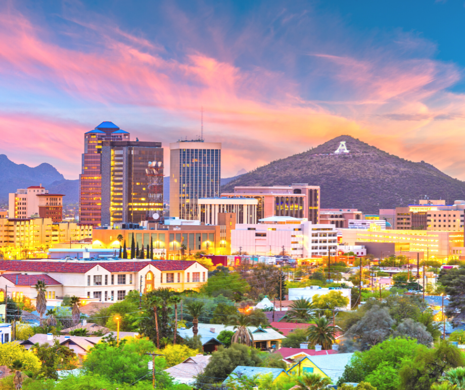 View of downtown Tucson at dusk. "A" Mountain is in the back right of the image just behind the cityscape of downtown.